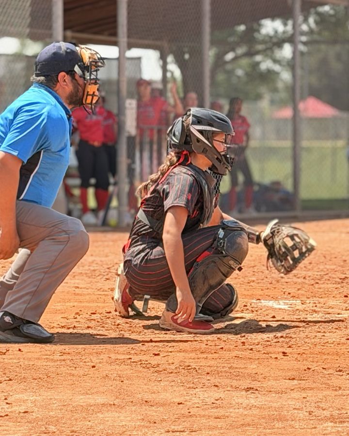 Mia Mead receiving a pitch behind the plate during a game